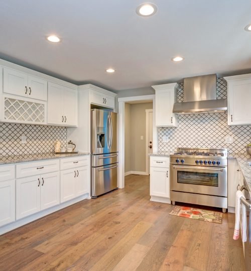 Gorgeous white kitchen room with Moroccan Tiles Backsplash and modern stainless steel appliances.