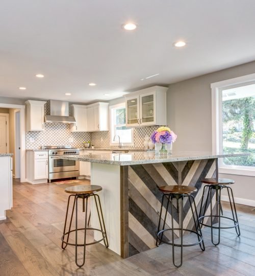 Gorgeous white kitchen with island and bar stools.